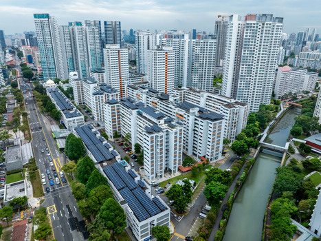 Aerial view of Whampoa River winding through a dense residential district with high rise apartment blocks lush greenery and a busy road in Singapore Singapore. Aerial view of Whampoa River winding through a dense residential district with high rise apartment blocks lush greenery and a busy road in Singapore Singapore.