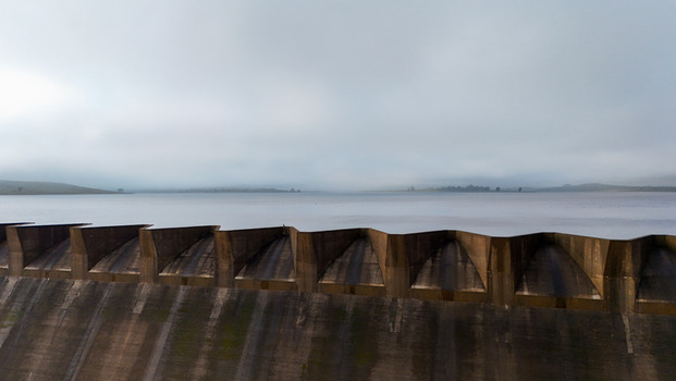 Aerial view of the concrete spillway of Spring Grove Dam and the calm reservoir under a thick layer of morning mist in Mooi River KwaZulu Natal South Africa. Aerial view of the concrete spillway of Spring Grove Dam and the calm reservoir under a thick layer of morning mist in Mooi River KwaZulu Natal South Africa.