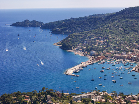 Aerial view of the harbor and coastal town with boats moored in the blue water and lush green hills Santa Margherita Ligure Liguria Italy. Aerial view of the harbor and coastal town with boats moored in the blue water and lush green hills Santa Margherita Ligure Liguria Italy.