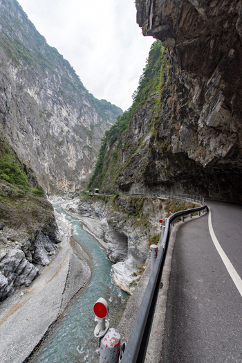 View of the winding road carved into the steep marble cliffs of Taroko National Park overlooking the turquoise Liwu River in Xiulin Township Hualien County Taiwan.
