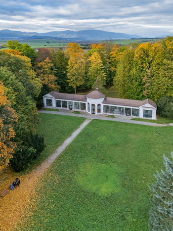 Aerial view of a historic pavilion stands amidst a vibrant tapestry of autumn foliage the scene bathed in the soft glow of a cloudy day Mosovce Zilina Region Slovakia. Aerial view of a historic pavilion stands amidst a vibrant tapestry of autumn foliage the scene bathed in the soft glow of a cloudy day Mosovce Zilina Region Slovakia.
