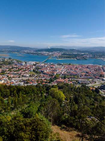Aerial view of the cityscape of Viana do Castelo featuring the Lima River the Eiffel Bridge and dense urban rooftops under a clear blue sky Viana do Castelo Viana do Castelo Dist Portugal. Aerial view of the cityscape of Viana do Castelo featuring the Lima River the Eiffel Bridge and dense urban rooftops under a clear blue sky Viana do Castelo Viana do Castelo Dist Portugal.