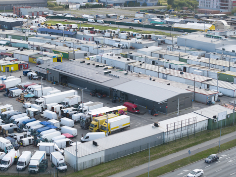 Krakow Poland 16 September 2026 Aerial view of Farmer s Market Rybitwy with numerous delivery trucks vans and warehouse buildings in a busy logistics area. Krakow Poland 16 September 2026 Aerial view of Farmer s Market Rybitwy with numerous delivery trucks vans and warehouse buildings in a busy logistics area.