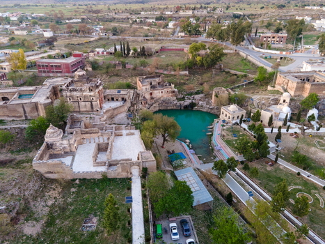 Aerial view of Katas Raj Temple Complex with its historic stone structures and turquoise pond surrounded by lush greenery and rural landscape in Katas Punjab Pakistan. Aerial view of Katas Raj Temple Complex with its historic stone structures and turquoise pond surrounded by lush greenery and rural landscape in Katas Punjab Pakistan.