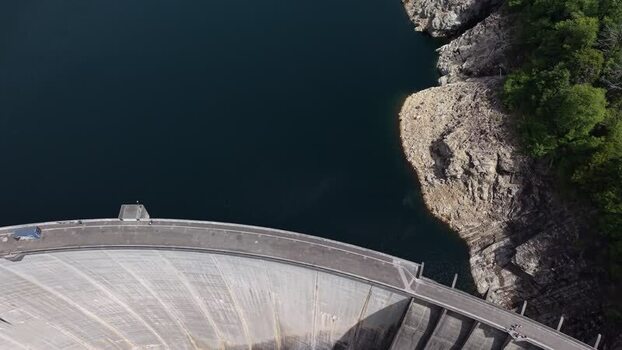 Aerial view of the Verzasca Dam and dark reservoir water Switzerland.