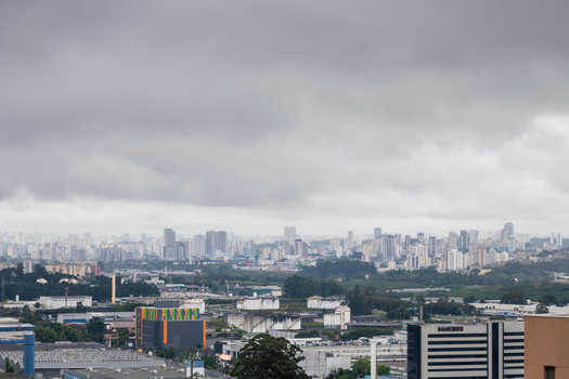 Sao Paulo Sao Paulo Brazil 14 September 2026 Aerial view of the dense urban skyline of Sao Paulo with industrial buildings in the foreground under a heavy overcast sky.
