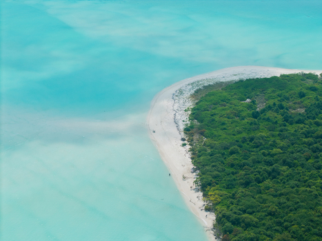 Aerial view of a lush green island embraced by the turquoise sea and white sandy beach a tropical paradise revealed from above Thuraakunu Thiladhunmathee Uthuruburi Maldives. Aerial view of a lush green island embraced by the turquoise sea and white sandy beach a tropical paradise revealed from above Thuraakunu Thiladhunmathee Uthuruburi Maldives.