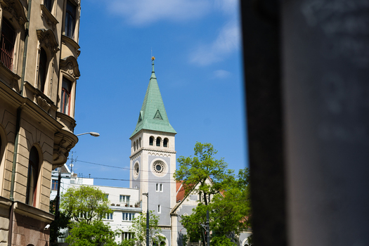 View of the Reformed Church tower with its distinctive green spire and historic facade under a clear blue sky in Bratislava Bratislava Region Slovakia. View of the Reformed Church tower with its distinctive green spire and historic facade under a clear blue sky in Bratislava Bratislava Region Slovakia.