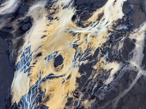 Aerial view of a glacial river in Iceland showing intricate braided channels with contrasting dark volcanic sand and bright sediment rich water. Iceland. Aerial view of a glacial river in Iceland showing intricate braided channels with contrasting dark volcanic sand and bright sediment rich water. Iceland.