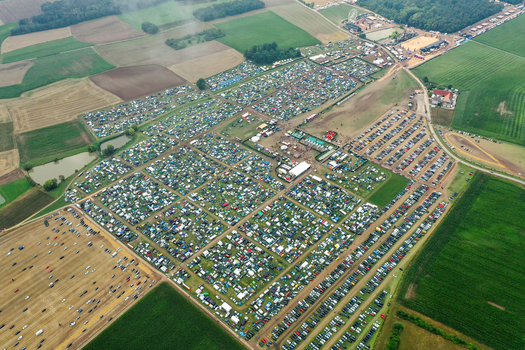 Herzogenaurach Germany 27 July 2025 Aerial view of the Open Beatz Festival campsite with thousands of tents and parked cars surrounded by agricultural fields. Herzogenaurach Germany 27 July 2025 Aerial view of the Open Beatz Festival campsite with thousands of tents and parked cars surrounded by agricultural fields.
