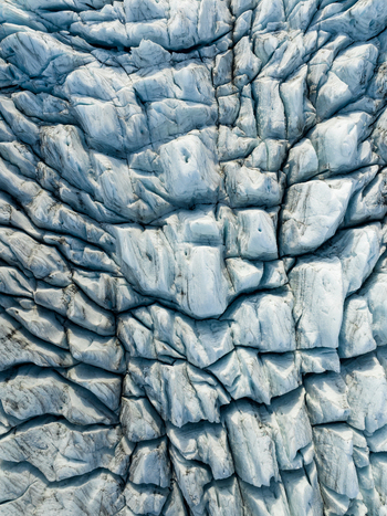 Aerial view of the glacier s icy labyrinth a symphony of blues and whites etched into the landscape Fjallsarlon Sveitarfélagið Hornafjörður Iceland. Aerial view of the glacier s icy labyrinth a symphony of blues and whites etched into the landscape Fjallsarlon Sveitarfélagið Hornafjörður Iceland.