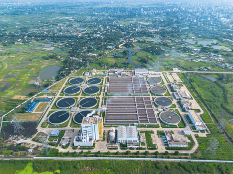 Aerial view of the Sewage Treatment Plant Dhaka WASA with circular clarifier tanks and rectangular basins surrounded by green fields in Dhaka Dhaka Division Bangladesh. Aerial view of the Sewage Treatment Plant Dhaka WASA with circular clarifier tanks and rectangular basins surrounded by green fields in Dhaka Dhaka Division Bangladesh.