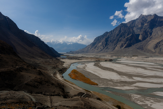 Aerial view of the Shigar Delta where the meandering Shigar River flows through the mountainous landscape featuring sandy riverbanks and rugged peaks in Shigar Gilgit Baltistan Pakistan. Aerial view of the Shigar Delta where the meandering Shigar River flows through the mountainous landscape featuring sandy riverbanks and rugged peaks in Shigar Gilgit Baltistan Pakistan.