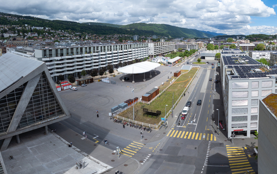 Aerial view of Esplanade Kongresshaus featuring a large white canopy and modern urban architecture surrounded by streets and distant hills in Biel Bienne Canton of Bern Switzerland. Aerial view of Esplanade Kongresshaus featuring a large white canopy and modern urban architecture surrounded by streets and distant hills in Biel Bienne Canton of Bern Switzerland.