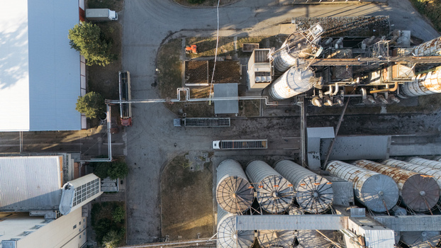 Aerial view of industrial grain silos and storage facilities with trucks parked in the yard in Sremska Mitrovica Vojvodina Serbia. Aerial view of industrial grain silos and storage facilities with trucks parked in the yard in Sremska Mitrovica Vojvodina Serbia.