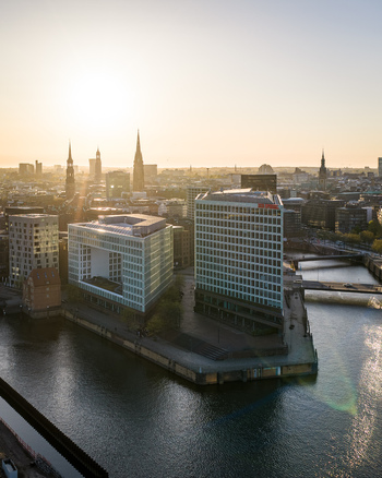 Hamburg Germany 22 April 2026 Aerial view of the Spiegel Building and modern architecture along the waterfront at sunset with the city skyline in the background.