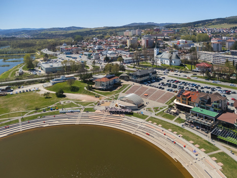 Aerial view of Oravska priehrada waterfront with the amphitheater and town skyline under a clear blue sky in Namestovo Zilinsky kraj Slovakia. Aerial view of Oravska priehrada waterfront with the amphitheater and town skyline under a clear blue sky in Namestovo Zilinsky kraj Slovakia.