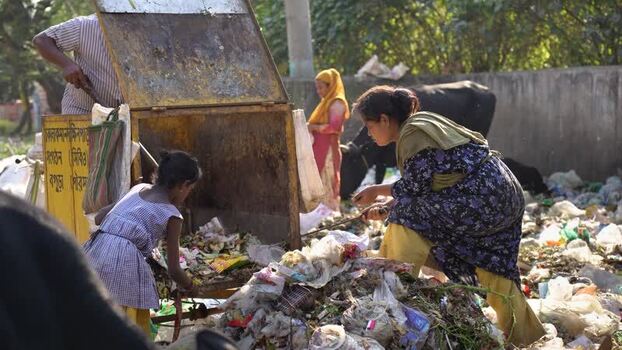 View of people sorting waste at a garbage dump in Bogura Bangladesh. View of people sorting waste at a garbage dump in Bogura Bangladesh.