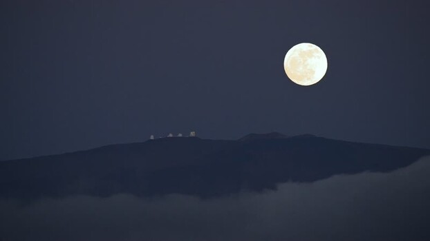 View of observatories on a mountain under a full moon United States. View of observatories on a mountain under a full moon United States.