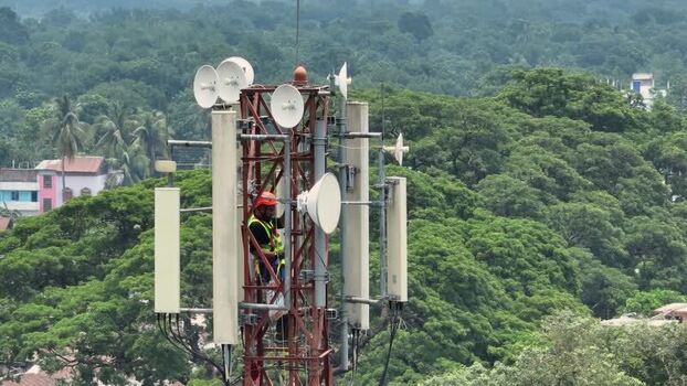 Aerial view of a technician working on a telecom tower Bangladesh.