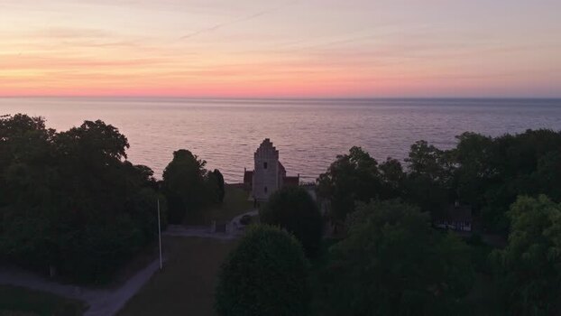 Aerial view of Old Hojerup Church at sunrise in Denmark.
