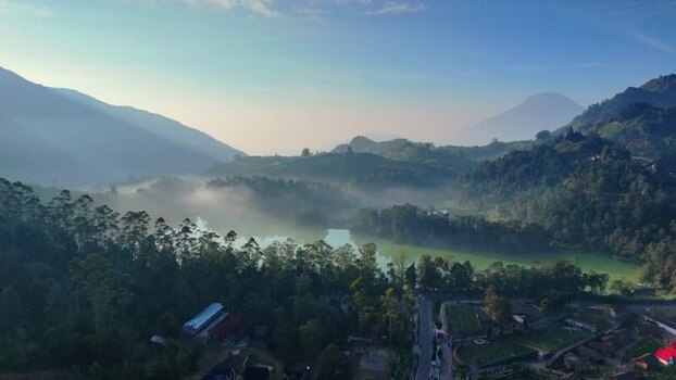 Aerial view of a misty lake and green mountains in Indonesia. Aerial view of a misty lake and green mountains in Indonesia.