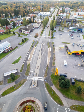 Muhos Finland 22 September 2026 Aerial view of the town center in Muhos featuring a roundabout main road commercial buildings and surrounding autumn trees in North Ostrobothnia.