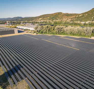 Aerial view of solar photovoltaic panels forming geometric rows at a utility scale solar farm in Le Pouzin Auvergne Rhone Alpes France. Aerial view of solar photovoltaic panels forming geometric rows at a utility scale solar farm in Le Pouzin Auvergne Rhone Alpes France.