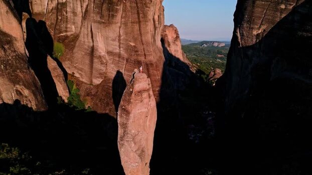 Aerial view of Meteora rock pinnacle with person Greece.