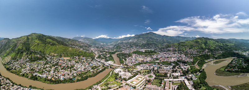Aerial view of Muzaffarabad city nestled in the mountains featuring the confluence of the Jhelum and Neelum rivers and dense urban development. Muzaffarabad Azad Kashmir Pakistan. Aerial view of Muzaffarabad city nestled in the mountains featuring the confluence of the Jhelum and Neelum rivers and dense urban development. Muzaffarabad Azad Kashmir Pakistan.