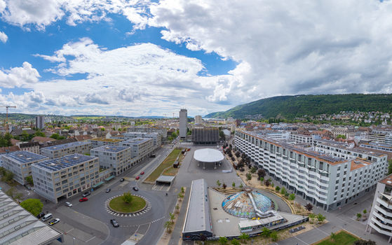 Aerial view of Esplanade Kongresshaus 11 featuring modern architecture a large white canopy and a roundabout under a cloudy sky in Biel Bienne Canton of Bern Switzerland. Aerial view of Esplanade Kongresshaus 11 featuring modern architecture a large white canopy and a roundabout under a cloudy sky in Biel Bienne Canton of Bern Switzerland.
