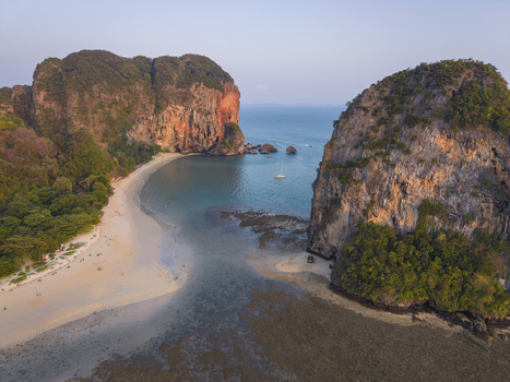 Aerial view of the soft sandy beach nestled between towering cliffs and the turquoise sea a serene coastal haven Krabi Thailand.