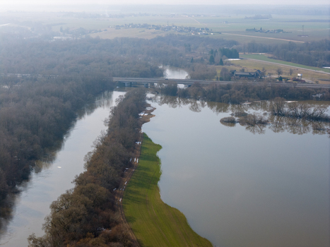 Aerial view of the flooded Nemunas river banks with bare trees and a road bridge under a hazy sky in Kaniukai Kaunas County Lithuania. Aerial view of the flooded Nemunas river banks with bare trees and a road bridge under a hazy sky in Kaniukai Kaunas County Lithuania.