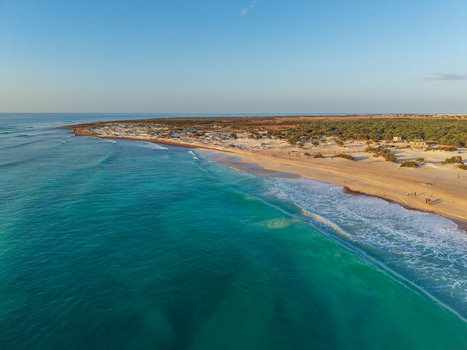 Aerial view of turquoise waters meeting the sandy shore contrasting with the arid landscape Kadrihnitin Socotra Yemen. Aerial view of turquoise waters meeting the sandy shore contrasting with the arid landscape Kadrihnitin Socotra Yemen.