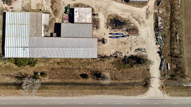 Aerial view of buildings casting long shadows on the dry sun baked earth near a road Elkton Florida United States. Aerial view of buildings casting long shadows on the dry sun baked earth near a road Elkton Florida United States.