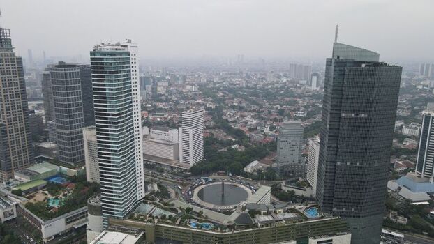 Aerial view of the Bundaran HI roundabout surrounded by modern skyscrapers and urban greenery in the heart of the city Kecamatan Menteng Daerah Khusus Ibukota Indonesia. Aerial view of the Bundaran HI roundabout surrounded by modern skyscrapers and urban greenery in the heart of the city Kecamatan Menteng Daerah Khusus Ibukota Indonesia.