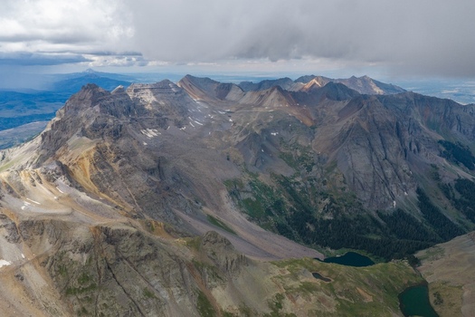 Aerial view of Mount Sneffels and the rugged peaks of the San Juan Mountains with alpine lakes and rocky slopes in Ouray County Colorado United States. Aerial view of Mount Sneffels and the rugged peaks of the San Juan Mountains with alpine lakes and rocky slopes in Ouray County Colorado United States.