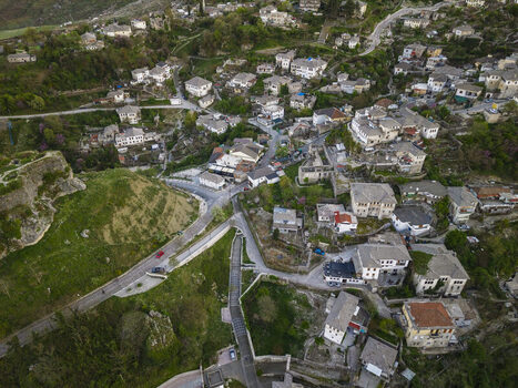 Aerial view of the historic town of Gjirokaster featuring traditional stone houses winding streets and the Gjirokaster Castle area in Gjirokaster Gjirokaster County Albania. Aerial view of the historic town of Gjirokaster featuring traditional stone houses winding streets and the Gjirokaster Castle area in Gjirokaster Gjirokaster County Albania.