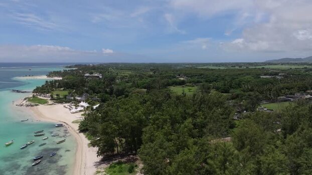 Aerial view of Belle Mare Beach with boats in Mauritius.