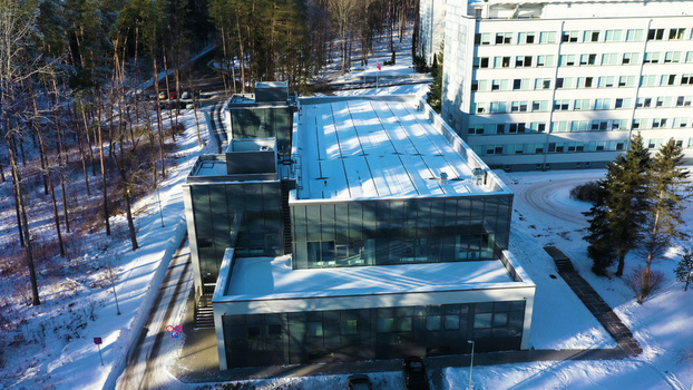 Aerial view of Vidzeme Hospital surrounded by snow covered grounds and pine trees in Valmiera Latvia. Aerial view of Vidzeme Hospital surrounded by snow covered grounds and pine trees in Valmiera Latvia.