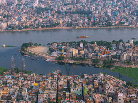 Aerial view of the Buriganga River flowing through the densely populated urban landscape of Keraniganj Dhaka Division Bangladesh. Aerial view of the Buriganga River flowing through the densely populated urban landscape of Keraniganj Dhaka Division Bangladesh.
