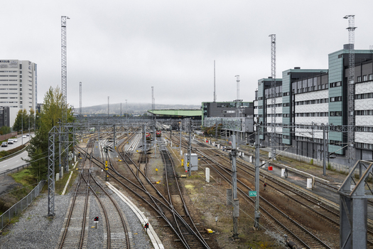 View of railway tracks and station infrastructure with modern buildings in the background in Jyvaskyla Central Finland Finland.
