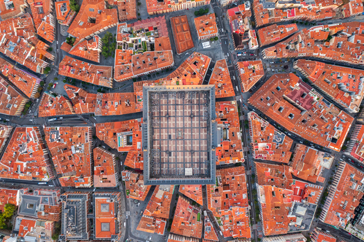 Aerial view of Plaza Mayor surrounded by historic terracotta rooftops and dense urban architecture in Madrid Community of Madrid Spain. Aerial view of Plaza Mayor surrounded by historic terracotta rooftops and dense urban architecture in Madrid Community of Madrid Spain.