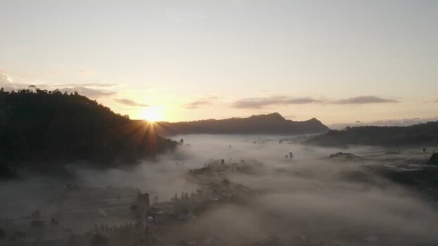 Aerial view of sunrise over a misty valley and mountains Indonesia. Aerial view of sunrise over a misty valley and mountains Indonesia.