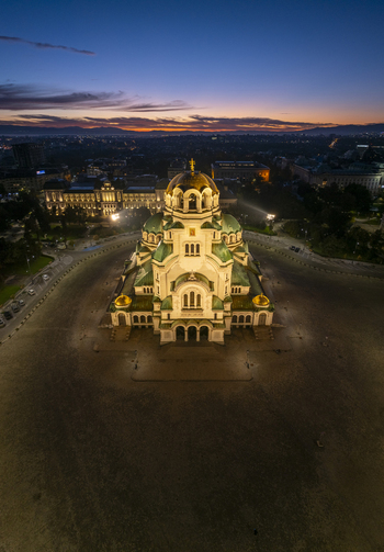 Aerial view of the illuminated Patriarchal Cathedral St. Alexander Nevsky at dusk with golden domes and neo Byzantine architecture in Sofia Sofia City Province Bulgaria. Aerial view of the illuminated Patriarchal Cathedral St. Alexander Nevsky at dusk with golden domes and neo Byzantine architecture in Sofia Sofia City Province Bulgaria.