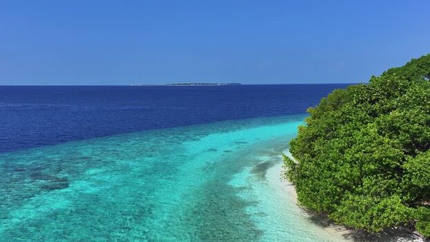 Aerial view of a tropical coastline and turquoise lagoon Maldives. Aerial view of a tropical coastline and turquoise lagoon Maldives.