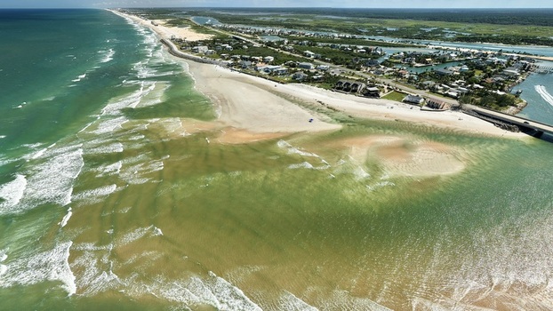 Aerial view of Matanzas Inlet showing the tidal channel sandbars coastal homes and the bridge crossing the water in St. Johns County Florida United States. Aerial view of Matanzas Inlet showing the tidal channel sandbars coastal homes and the bridge crossing the water in St. Johns County Florida United States.
