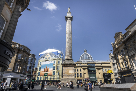 Newcastle upon Tyne England United Kingdom 13 July 2026 View of Grey s Monument in a bustling city square surrounded by historic stone buildings shops and people on a sunny day. Newcastle upon Tyne England United Kingdom 13 July 2026 View of Grey s Monument in a bustling city square surrounded by historic stone buildings shops and people on a sunny day.