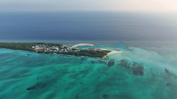Aerial view of Fulhadhoo island with turquoise waters and reefs Maldives. Aerial view of Fulhadhoo island with turquoise waters and reefs Maldives.