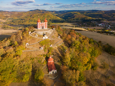 Aerial view of the Stiavnicka Kalvaria pilgrimage site featuring its hilltop church and winding paths surrounded by autumn forests in Banska Stiavnica Banskobystricky kraj Slovakia. Aerial view of the Stiavnicka Kalvaria pilgrimage site featuring its hilltop church and winding paths surrounded by autumn forests in Banska Stiavnica Banskobystricky kraj Slovakia.